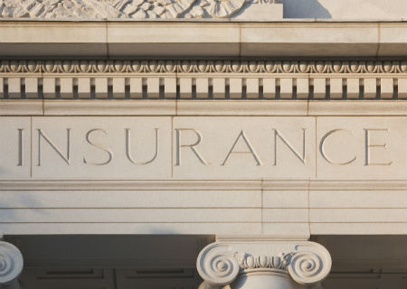Insurance carved into a building