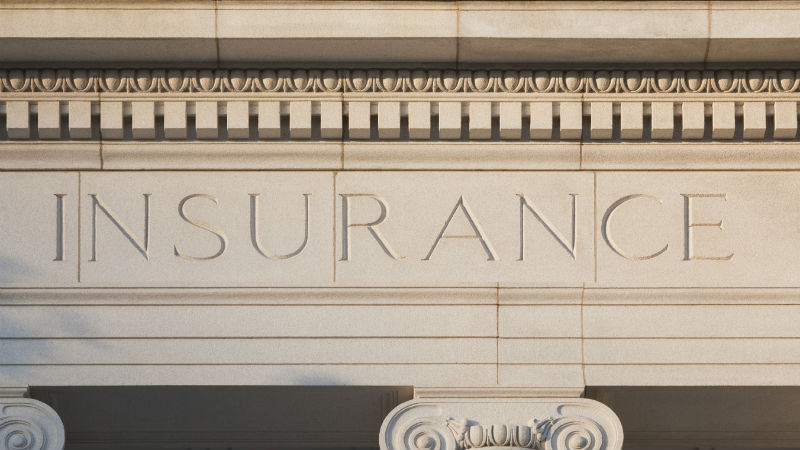 Insurance carved into a building