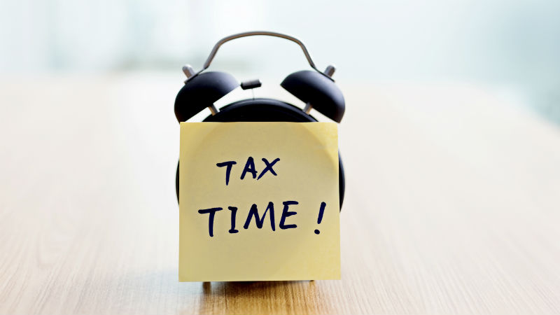 Alarm clock with Tax Time written on a note