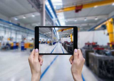 Photo being taken of the inside of a factory on a tablet