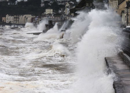 Waves crashing against sea wall in Dawlish