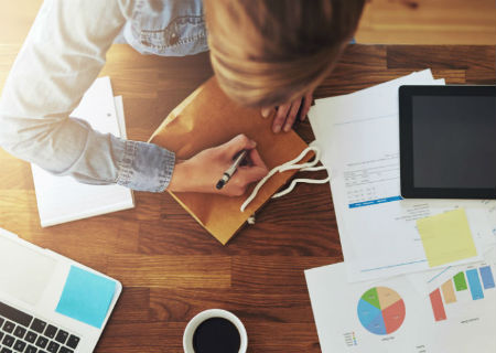 Woman writing notes from above