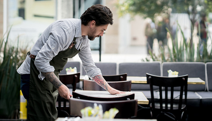 Waiter clearing a table