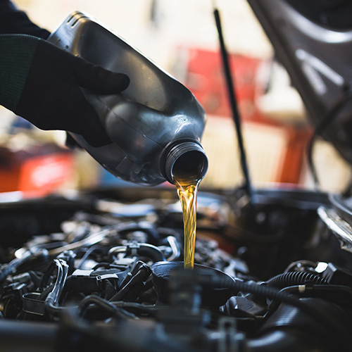 Oil being poured into a car