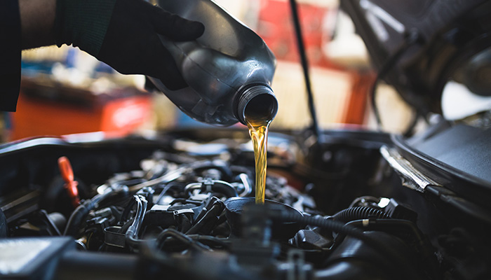 Oil being poured into a car