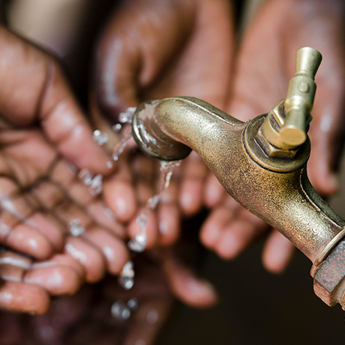 Hands under a tap