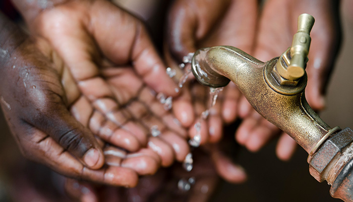 Hands under a tap