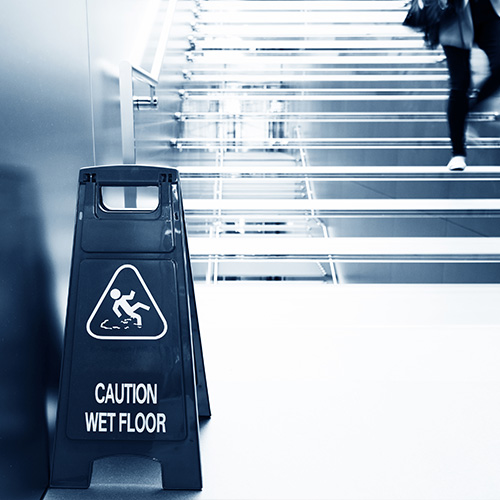 Caution Wet Floor sign at bottom of stairs