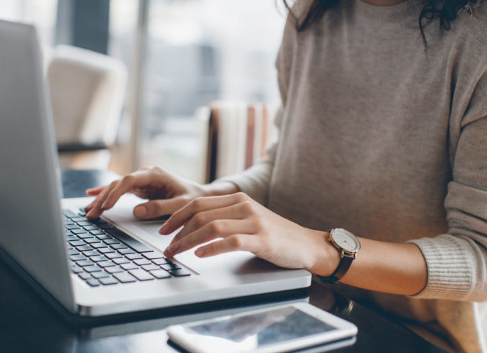 Woman typing on a laptop