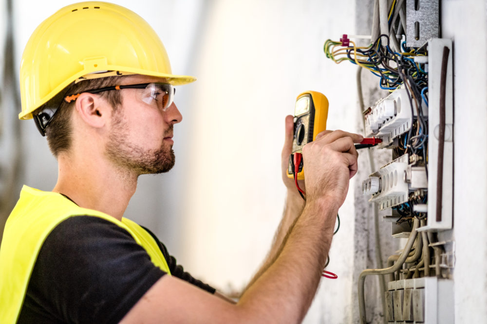 Electrician repairing circuit breakers